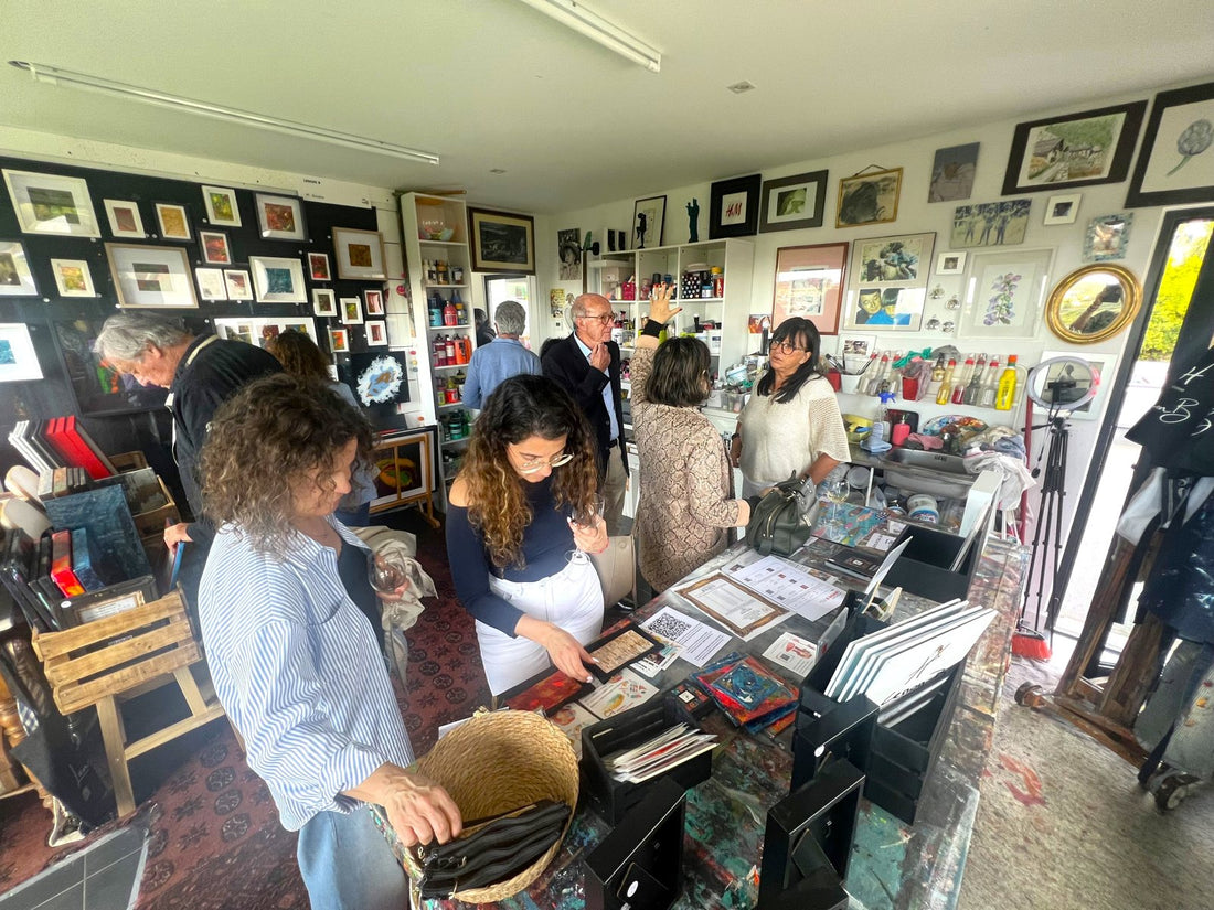 Visitors around the big table in Lenon B's painting studio in Ericeira