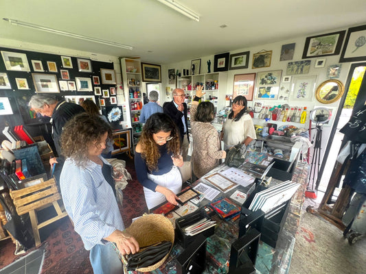 Visitors around the big table in Lenon B's painting studio in Ericeira