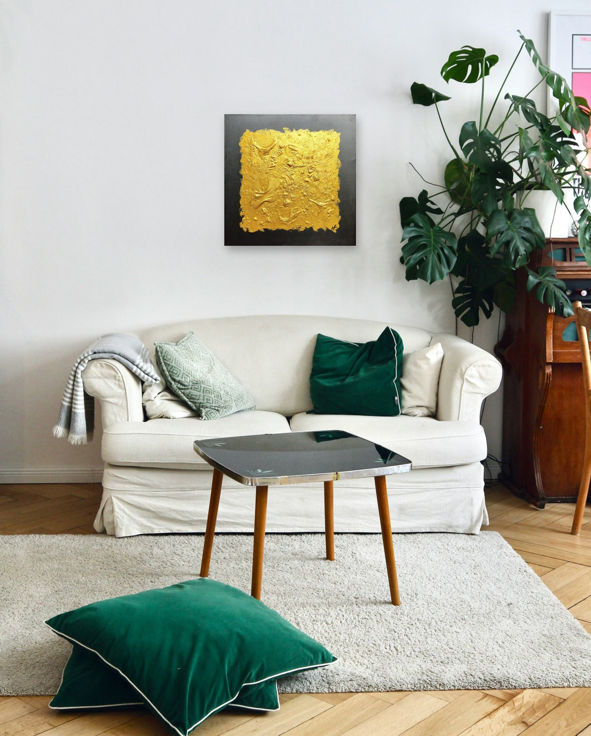 Gold IV by Lenon B on a white wall above a linen sofa