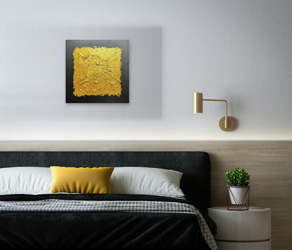 Gold IV by Lenon B above a black velvet bed, beside a brass wall light